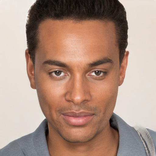 Joyful white young-adult male with short  black hair and brown eyes