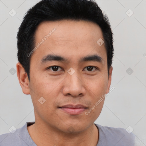 Joyful asian young-adult male with short  black hair and brown eyes