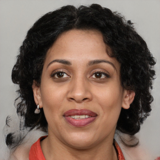 Joyful black adult female with medium  brown hair and brown eyes
