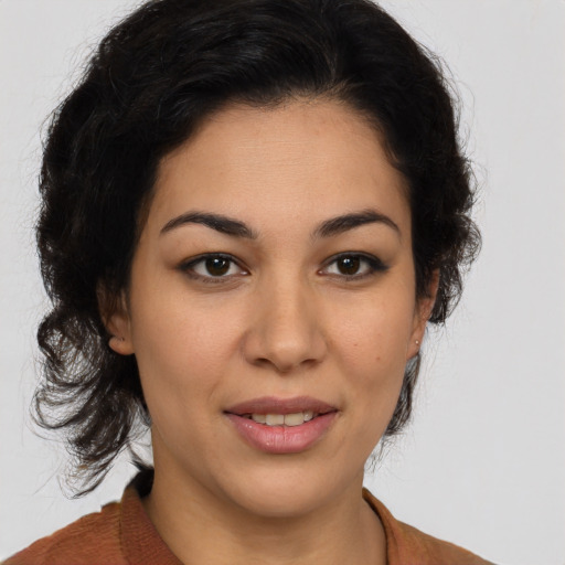 Joyful latino young-adult female with medium  brown hair and brown eyes