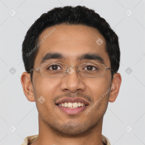 Joyful latino young-adult male with short  black hair and brown eyes