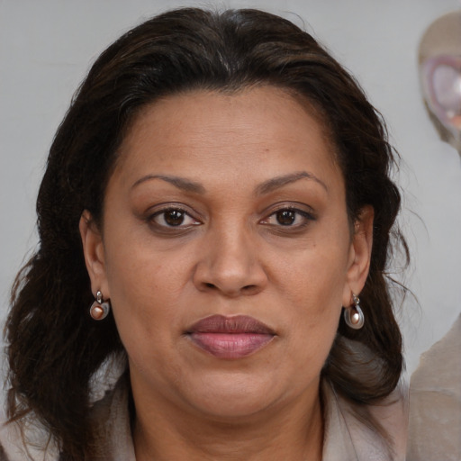 Joyful black adult female with medium  brown hair and brown eyes