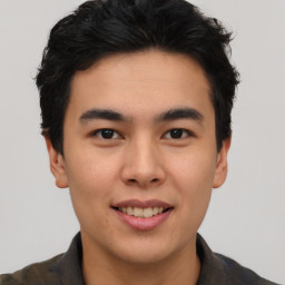 Joyful asian young-adult male with short  black hair and brown eyes