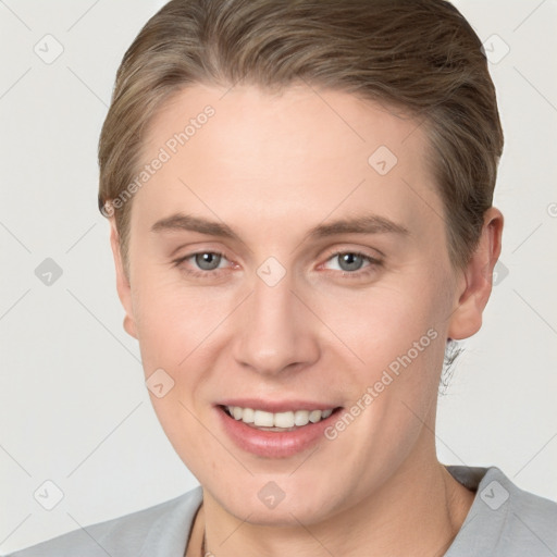 Joyful white young-adult female with short  brown hair and grey eyes