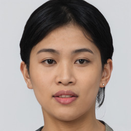 Joyful asian young-adult female with short  black hair and brown eyes