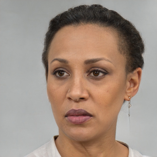 Neutral latino adult female with short  brown hair and brown eyes