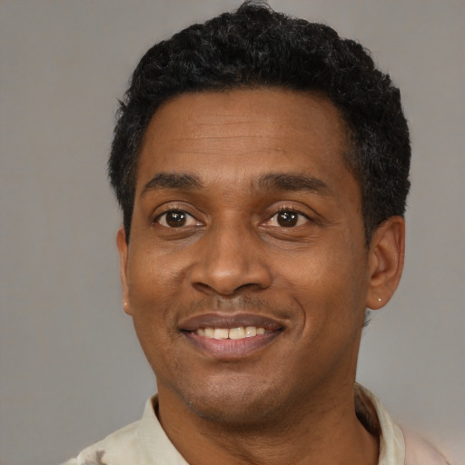 Joyful latino adult male with short  black hair and brown eyes