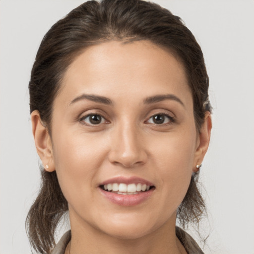 Joyful white young-adult female with medium  brown hair and brown eyes