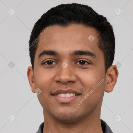 Joyful latino young-adult male with short  black hair and brown eyes