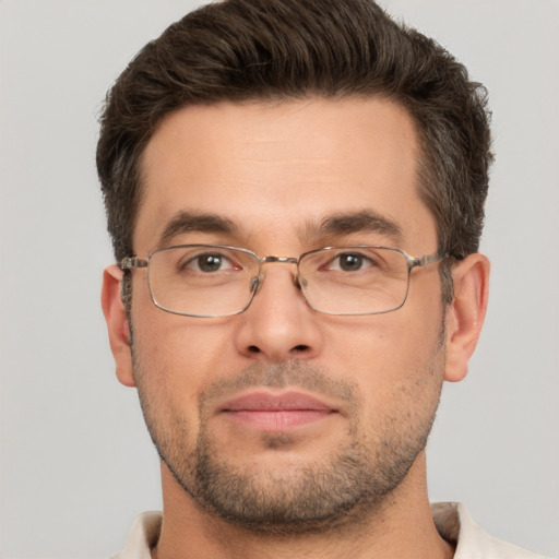 Joyful white adult male with short  brown hair and brown eyes