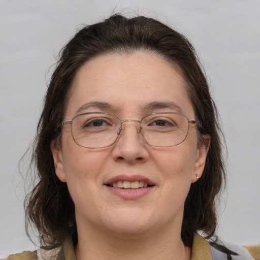 Joyful white adult female with medium  brown hair and brown eyes