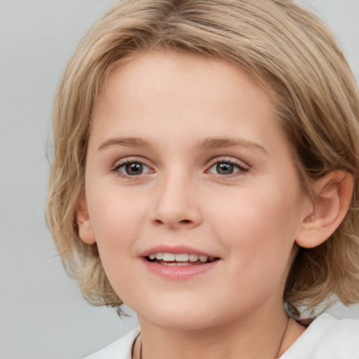 Joyful white child female with medium  brown hair and blue eyes