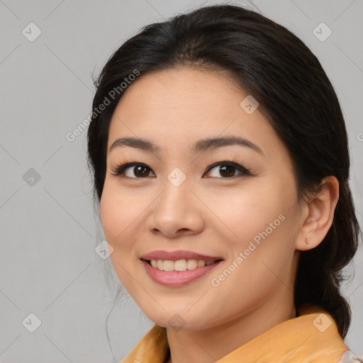 Joyful asian young-adult female with medium  black hair and brown eyes