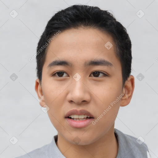 Joyful asian young-adult male with short  black hair and brown eyes