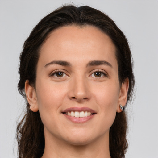 Joyful white young-adult female with medium  brown hair and brown eyes