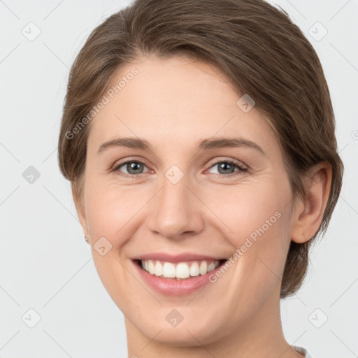 Joyful white young-adult female with medium  brown hair and grey eyes