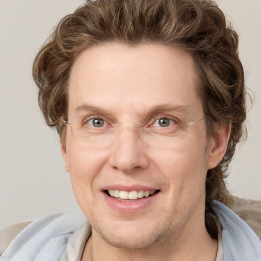 Joyful white adult male with short  brown hair and grey eyes