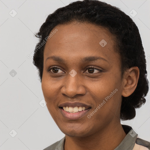 Joyful black young-adult female with short  black hair and brown eyes