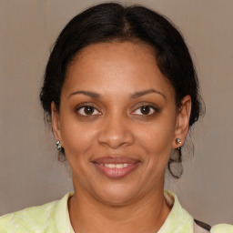 Joyful black young-adult female with medium  brown hair and brown eyes