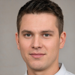 Joyful white young-adult male with short  brown hair and brown eyes