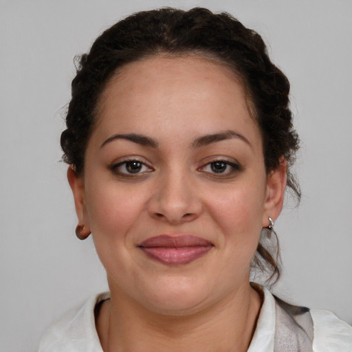 Joyful black young-adult female with medium  brown hair and brown eyes