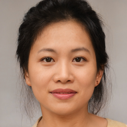 Joyful asian young-adult female with medium  brown hair and brown eyes