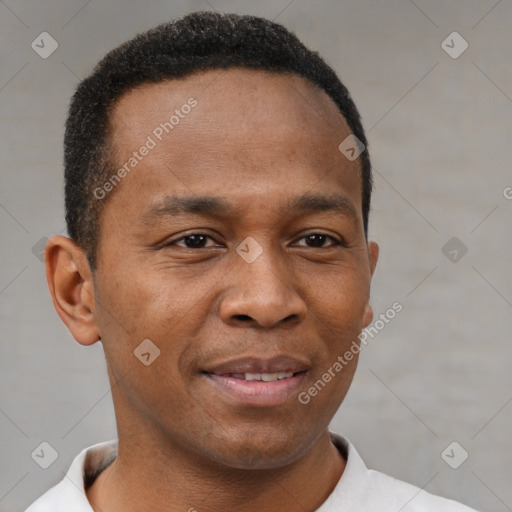 Joyful black young-adult male with short  brown hair and brown eyes