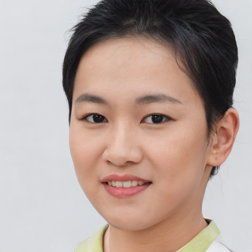 Joyful asian young-adult female with short  brown hair and brown eyes