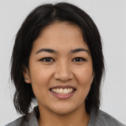 Joyful asian young-adult female with medium  black hair and brown eyes