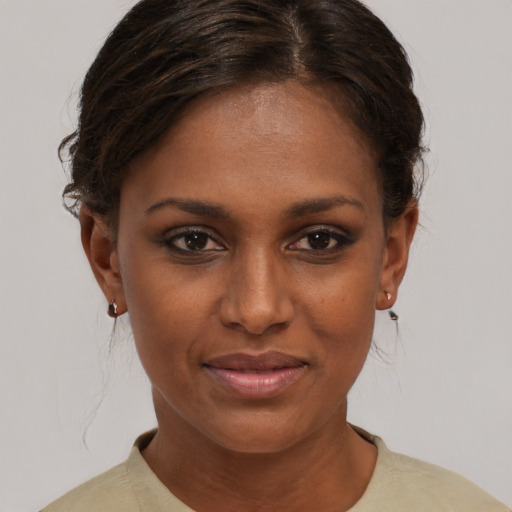 Joyful black young-adult female with short  brown hair and brown eyes