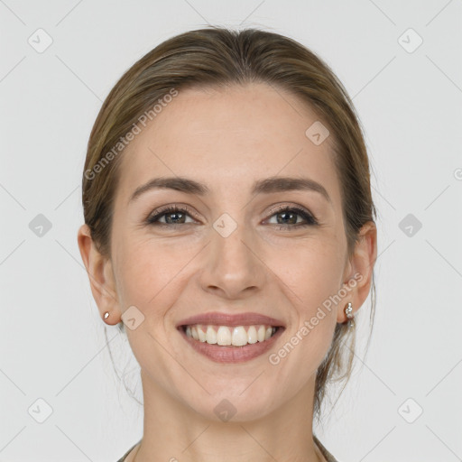 Joyful white young-adult female with medium  brown hair and grey eyes