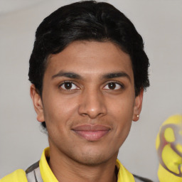 Joyful latino young-adult male with short  brown hair and brown eyes