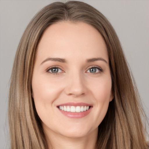 Joyful white young-adult female with long  brown hair and brown eyes