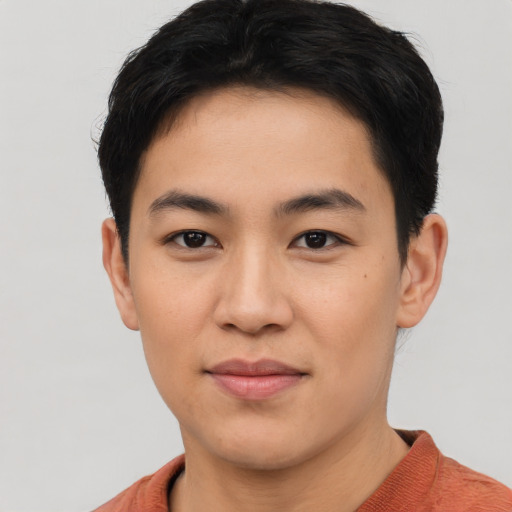 Joyful asian young-adult male with short  black hair and brown eyes