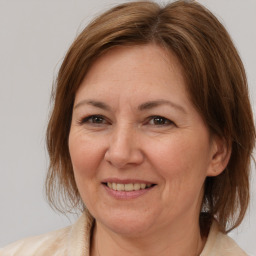 Joyful white adult female with medium  brown hair and brown eyes