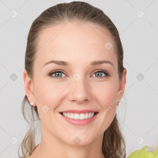 Joyful white young-adult female with medium  brown hair and grey eyes