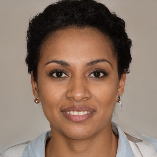 Joyful black young-adult female with short  black hair and brown eyes