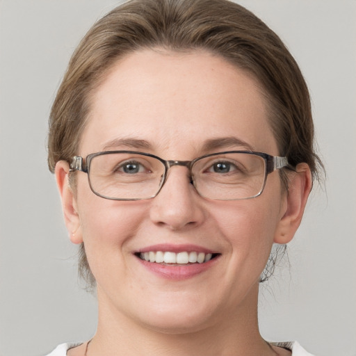 Joyful white adult female with medium  brown hair and grey eyes