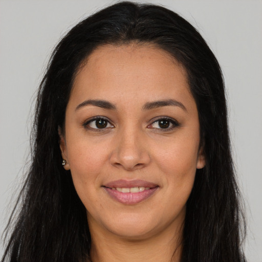 Joyful latino young-adult female with long  brown hair and brown eyes