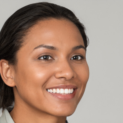 Joyful latino young-adult female with medium  brown hair and brown eyes