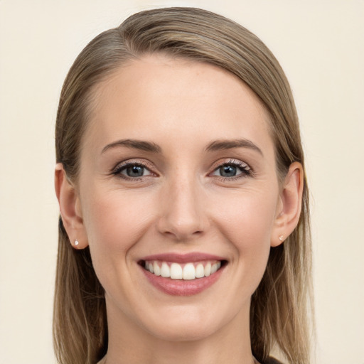 Joyful white young-adult female with long  brown hair and grey eyes