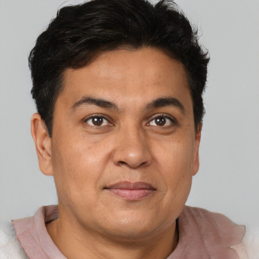 Joyful latino adult male with short  brown hair and brown eyes