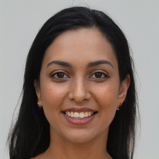 Joyful latino young-adult female with long  brown hair and brown eyes