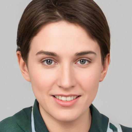 Joyful white young-adult female with short  brown hair and grey eyes