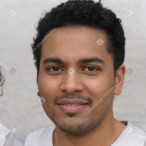 Joyful latino young-adult male with short  black hair and brown eyes