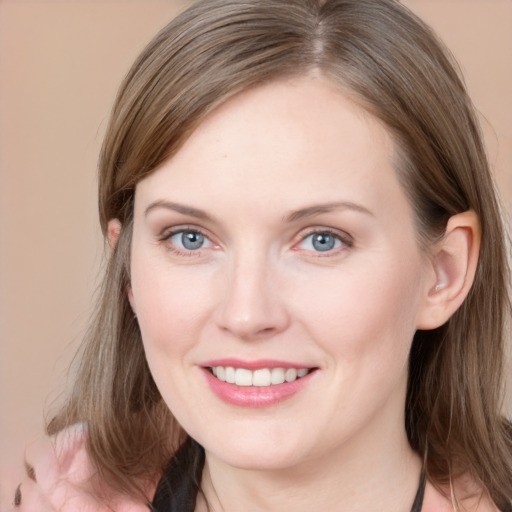 Joyful white young-adult female with medium  brown hair and grey eyes