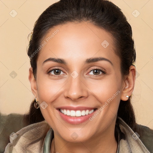 Joyful white young-adult female with long  brown hair and brown eyes