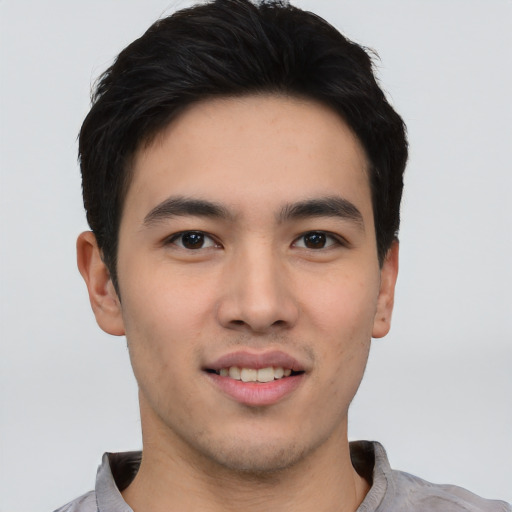 Joyful asian young-adult male with short  black hair and brown eyes