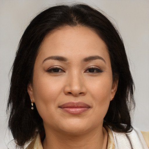 Joyful asian young-adult female with long  brown hair and brown eyes