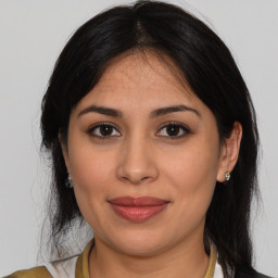 Joyful latino young-adult female with medium  brown hair and brown eyes